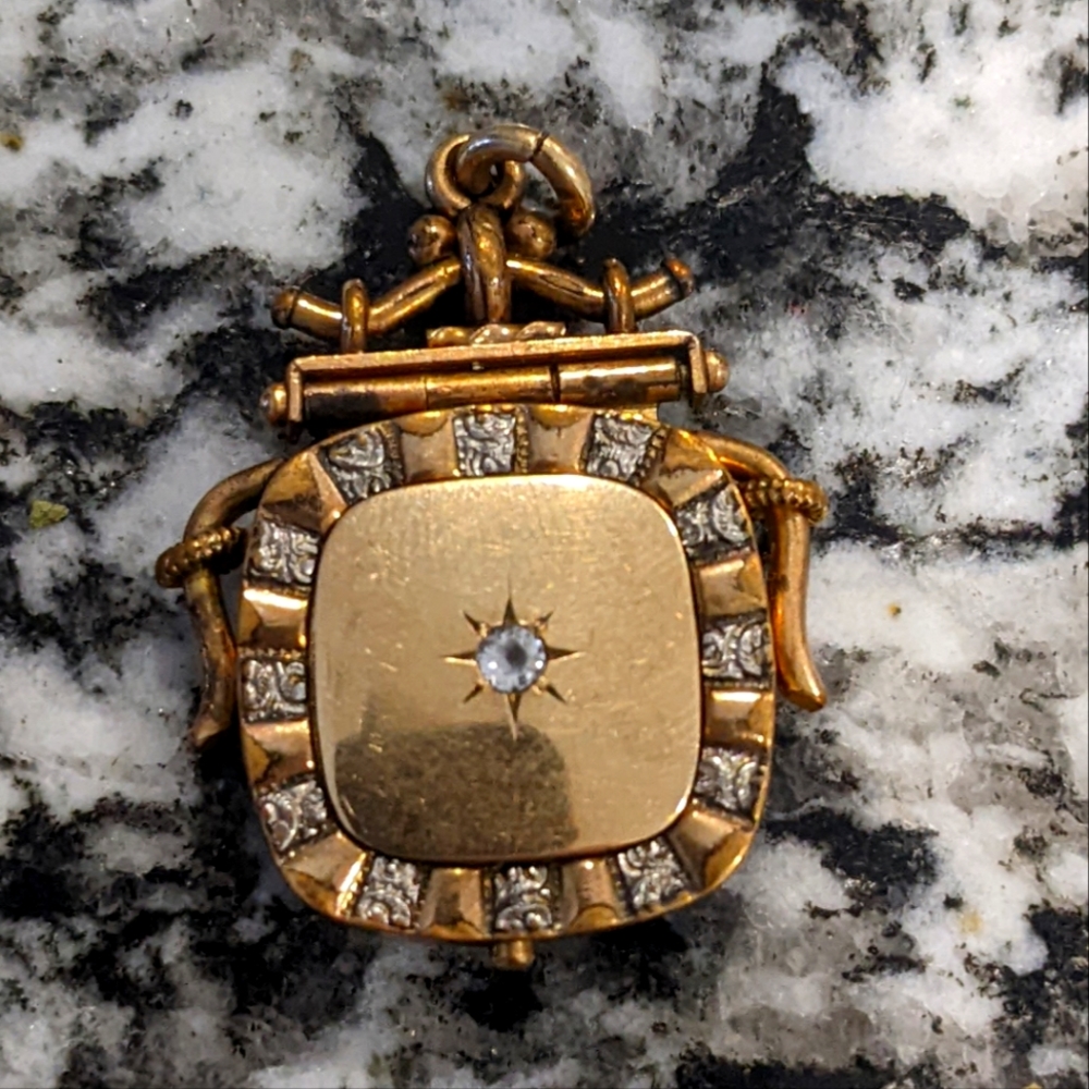 White and gold locket